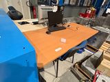 a desk with a computer on it in a warehouse