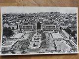 black and white photograph of a view of a city from the top of a building