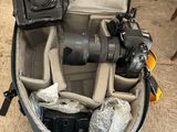 a camera and other items in a bag on the floor