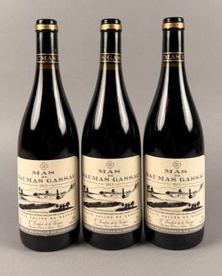 trois bouteilles de vin posées sur une table l'une à côté de l'autre