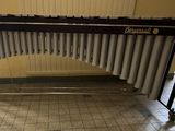 a black and white instrument on a stand in a room