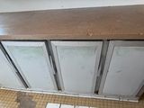 a kitchen counter that has a lot of glass doors on it