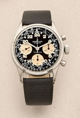 a close up of a watch on a white surface