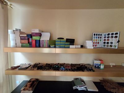 a desk with a computer, books, and other items on it