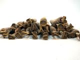 a lot of small wooden figurines sitting on a white surface