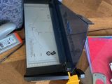 a table with a laptop, a ruler, a ruler, and other office supplies on it