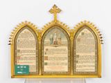 a gold frame with a cross on top of it