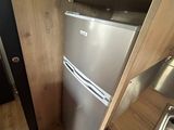 a small kitchen with a refrigerator and a sink in it