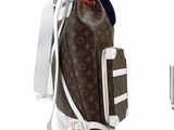 a brown and white backpack with a blue hat on top of it