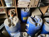 many blue barrels sitting next to each other in a room