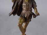 bronze figurine of a woman holding a bird on a pedestal