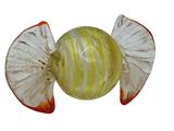 a glass object with a yellow and white design on it