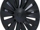 a close up of a black wheel cover on a white background