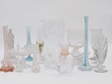 many different colored glass vases on a white surface
