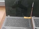 two laptops sitting on a table next to each other