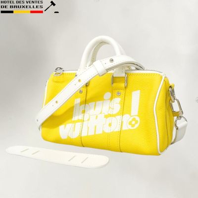 a yellow handbag with a white handle and a white strap