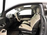 the interior of a car with the door open and the driver ' s seat down