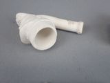 a white pipe sitting next to a black pipe on a table