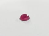 a red ruby gems on a white surface