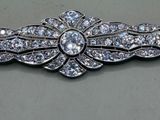a close up of a brooch with a lot of diamonds on it
