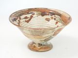 a brown and white bowl sitting on a white surface