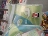 a person holding a nintendo wii game in their hand
