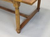 a wooden table with a glass top on a white floor
