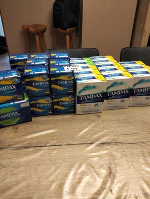 several boxes of tampax sitting on a table in a room