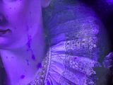 a picture of a woman with purple paint on her face