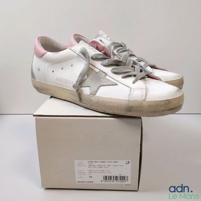 a box with a pair of white sneakers on it