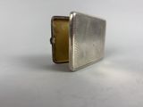 an antique silver cigarette case with a flower design on the front