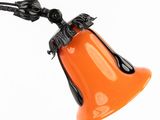 an orange bell hanging from a black cord