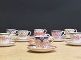 a lot of cups and saucers on the table