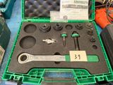 a green case with tools in it sitting on a table