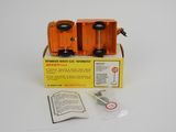 an orange box with a pair of scissors in it