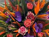 a bouquet of flowers on a table with a building in the background