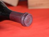 a bottle of wine sitting on a red table cloth
