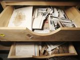 a drawer full of old photos and papers in it