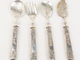 four spoons, forks and spoons are lined up on a white surface