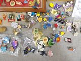 a lot of pins on the floor next to a picture frame