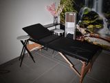 a massage table in a room with a waterfall in the background