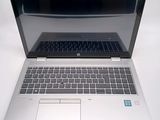 a laptop computer sitting on top of a white table