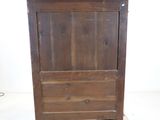 a wooden cabinet with a marble top on wheels