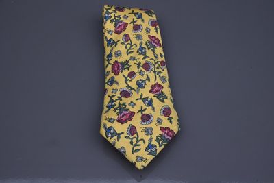 cravate à motifs floraux jaunes, avec des fleurs rouges et bleues sur fond noir