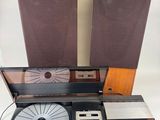 two speakers and a record player sitting on a table