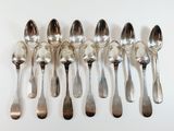 several spoons and spoon spoons are lined up on a white surface