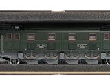 une boîte contenant un petit train, posée sur une surface blanche