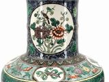 a vase with a floral design on it on a white background