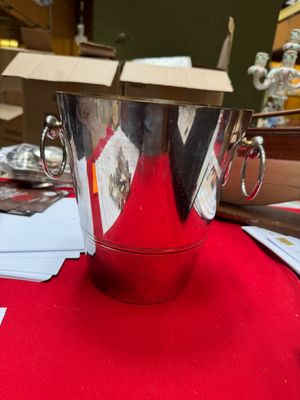 a silver ice bucket sitting on top of a red table