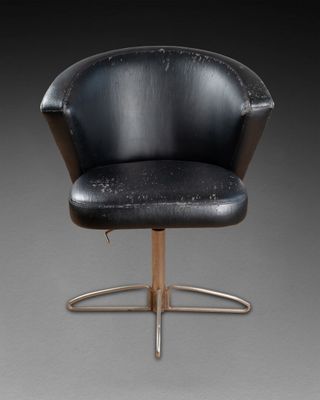 an image of a black chair with a wooden base and a black seat